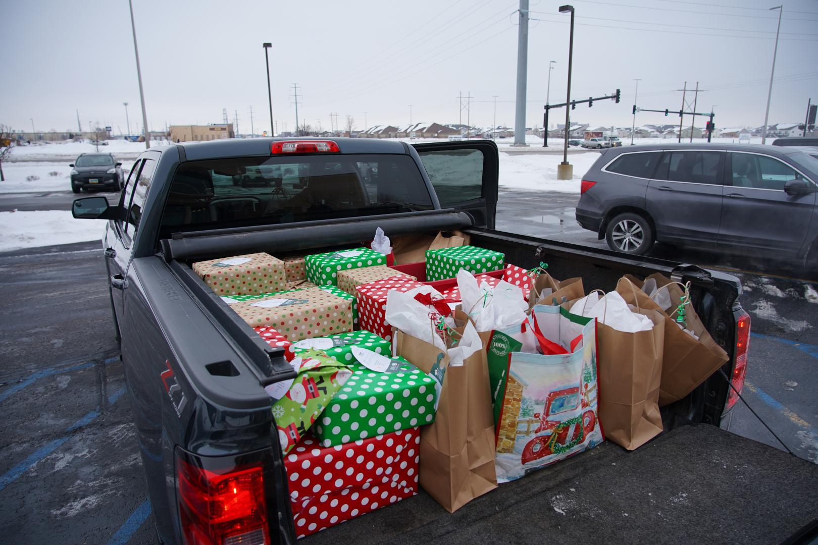 the back of a pickup truck filled with presents