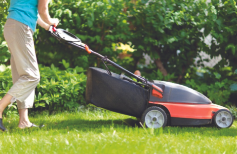 person using an electric lawnmower 