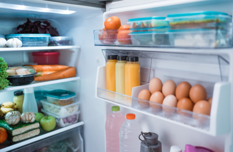 Open fridge with food inside